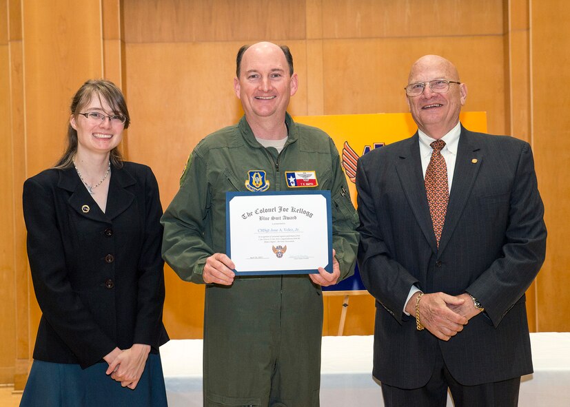 Col. Thomas K. Smith, Jr., 433rd Airlift Wing commander, accepts the Blue Suit Award  for Chief Master Sgt. Jose Velez, 433rd Maintenance Squadron first sergeant, at the Alamo Chapter Air Force Association luncheon April 20, 2017 at Monsignor Martin Family Center in San Antonio, Texas. 