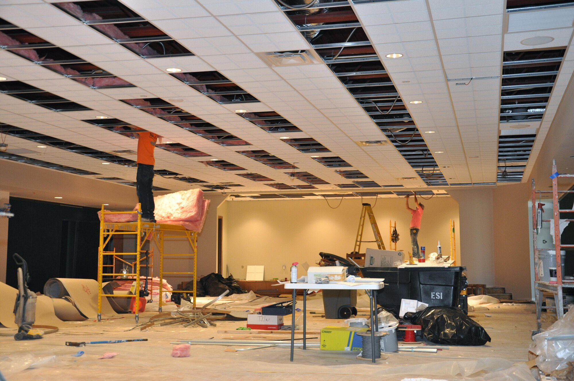 Construction workers lay insulation in the Wright-Patterson Club main ballroom on April 10, 2017. Improvements included leveling the ceiling, adding wings to the renovated stage, new flooring and upgraded lighting throughout that enables the ballroom, Daedallion Room and the Bicycle Lounge to have individual lighting controls for various events. The ballroom and adjacent rooms closed in December 2016 for the renovations, and are scheduled to reopen in late May. (U.S. Air Force photo/Jim Mitchell)