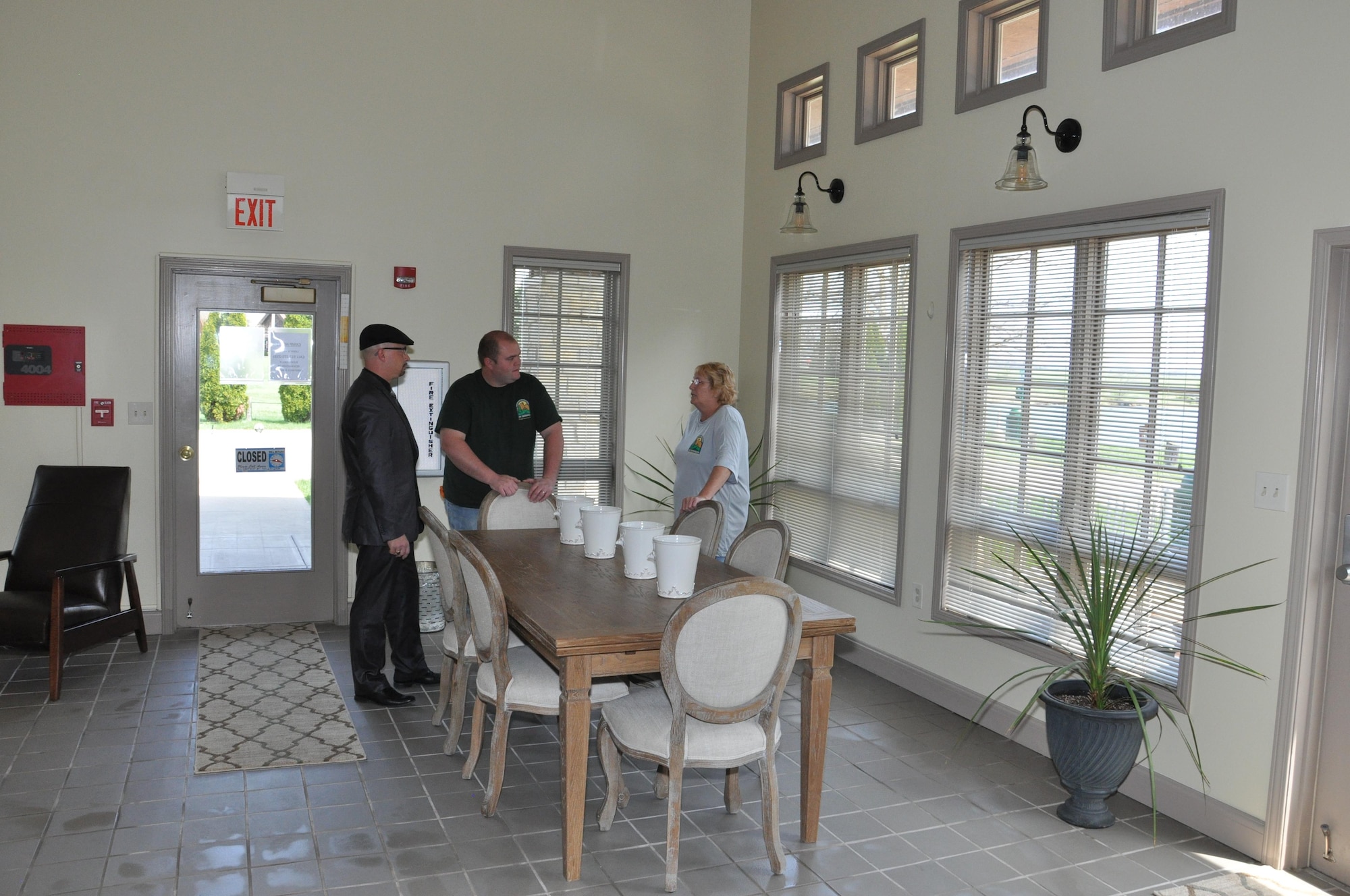 Brian Colonna, Chief, Community Services Flight, 88th Force Support Squadron, and Brandon Dixon, Outdoor Recreation Director, talk to Vickie Carman, a family camp volunteer about the facility facelift to the Family Camp Recreational Lodge at Wright-Patterson Air Force Base April 10, 2017. Improvements included new flooring, furniture and fixtures.  Work started in August 2016, and was finished in October 2016. The facility was able to remain open during the process. (U.S. Air Force photos/Jim Mitchell)