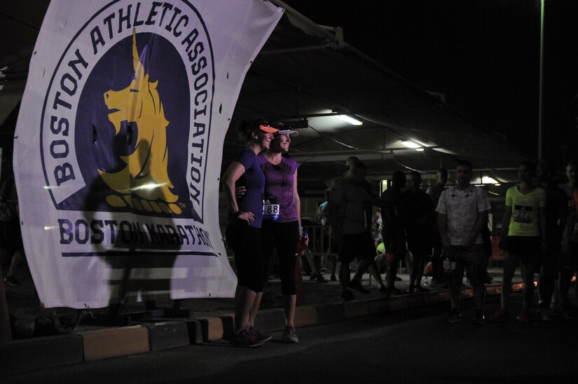 Two Boston Marathon Shadow Run participants pause for a photo in front of the Boston Athletic Association banner before the race, April 17, Camp Arifjan, Kuwait. The race kicked off at 4:00 a.m. and was officially supported by the Boston Athletic Association and the 121st Boston Marathon. More than 300 personnel throughout the U.S. Army Central area of operations participated in the marathon. (U.S. Army photo by Sgt. Kimberly Browne, USARCENT Public Affairs)