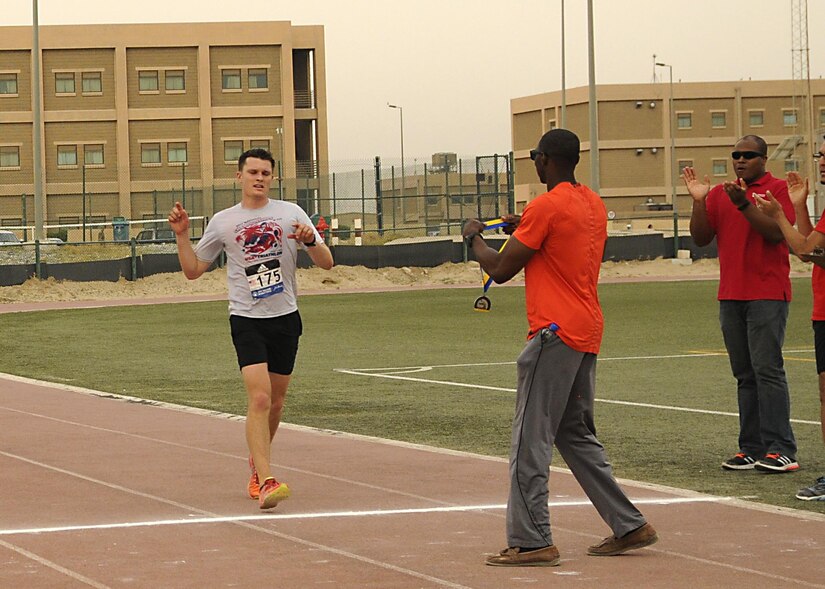 1st Lt. Grant Rice, a diver with the 511th Dive Detachment, finishes first in the men’s division with a time of three hours, three minutes, three seconds, in Camp Arifjan’s first Boston Marathon Shadow Run, April 17, Camp Arifjan, Kuwait. This race shadowed the 121st Boston Marathon, and gave deployed personnel an opportunity to run in the famous marathon. More than 300 people participated in the shadow run.  (U.S. Army photo by Sgt. Kimberly Browne, USARCENT Public Affairs)