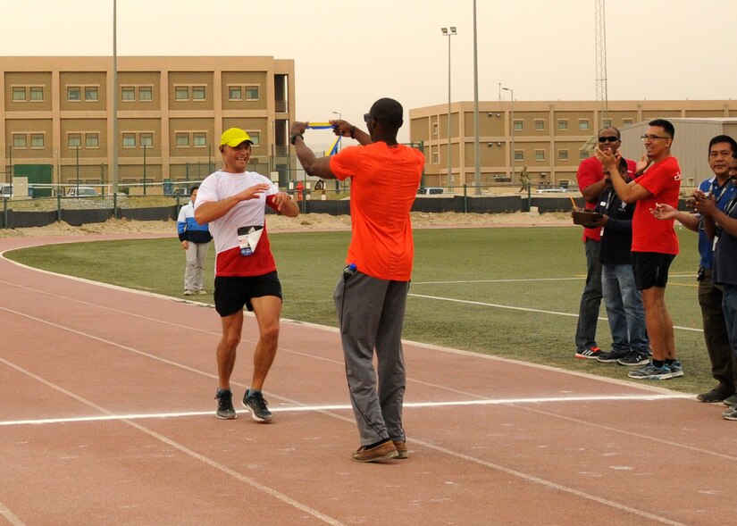 Warrant Officer Adam Fido, a member of the Polish air force, finishes in second place in the men’s division with a time of three hours, five minutes, 21 seconds, in Camp Arifjan’s first Boston Marathon Shadow Race, April 17, Camp Arifjan, Kuwait. This race shadowed the 121st Boston Marathon, and gave deployed personnel an opportunity to run in the well-known marathon. More than 300 people participated in the shadow run.  (U.S. Army photo by Sgt. Kimberly Browne, USARCENT Public Affairs)