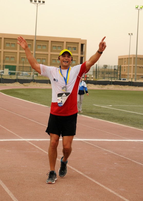Warrant Officer Adam Fido, a member of the Polish air force, celebrates after finishing and placing second in the men’s division with a time of three hours, five minutes, 21 seconds, in Camp Arifjan’s first Boston Marathon Shadow Run, April 17, Camp Arifjan, Kuwait. This race shadowed the 121st Boston Marathon, and gave deployed personnel an opportunity to run in the famous marathon. More than 300 people participated in the shadow run.  (U.S. Army photo by Sgt. Kimberly Browne, USARCENT Public Affairs)