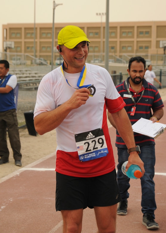 Warrant Officer Adam Fido, a member of the Polish air force, holds his Boston Marathon Shadow Run participation medal after placing second in the men’s division with a time of three hours, five minutes, 21 seconds, in Camp Arifjan’s first Boston Marathon Shadow Run, April 17, Camp Arifjan, Kuwait. This race shadowed the 121st Boston Marathon, and gave deployed personnel an opportunity to run in the famous marathon. More than 300 people participated in the shadow run.  (U.S. Army photo by Sgt. Kimberly Browne, USARCENT Public Affairs)