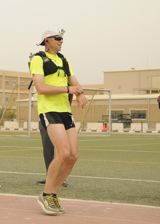 Sgt. Douglas Long, a Soldier with 1st Battalion, 12th Cavalry Regiment, 3rd Brigade Combat Team, 1st Cavalry Division, stops his watch after placing third in the men’s division with a time of less than three hours, 20 minutes, in Camp Arifjan’s first Boston Marathon Shadow Run, April 17, Camp Arifjan, Kuwait. This race shadowed the 121st Boston Marathon, and gave deployed personnel an opportunity to run in the well-known marathon. More than 300 people participated in the shadow run.  (U.S. Army photo by Sgt. Kimberly Browne, USARCENT Public Affairs)