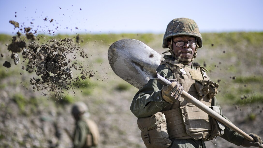 Marine Corps Pfc. Jason Taylor shovels dirt during airfield damage and repair training at Marine Corps Air Station Iwakuni, Japan, April 19, 2017. Taylor is a combat engineer assigned to Marine Wing Support Squadron 171. Marine Corps photo by Lance Cpl. Joseph Abrego