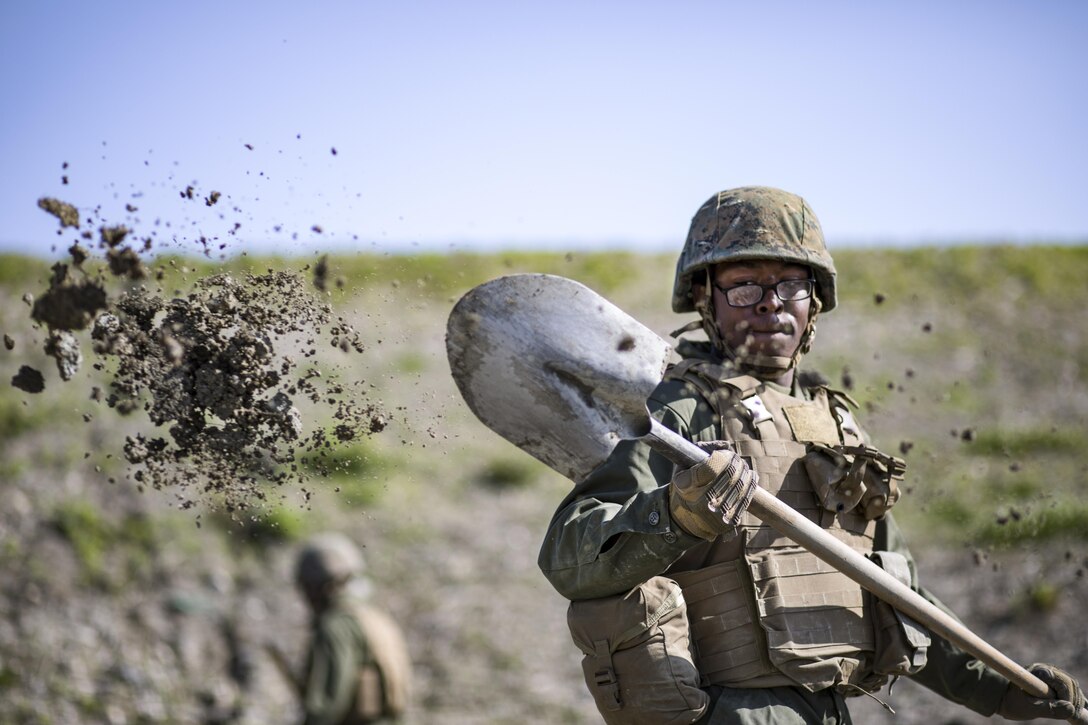 Marine Corps Pfc. Jason Taylor shovels dirt during airfield damage and repair training at Marine Corps Air Station Iwakuni, Japan, April 19, 2017. Taylor is a combat engineer assigned to Marine Wing Support Squadron 171. Marine Corps photo by Lance Cpl. Joseph Abrego