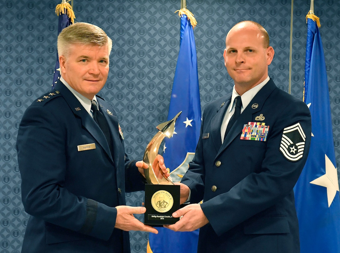 Lt. Gen. Jerry Harris, the deputy chief of staff for strategic plans, programs and requirements, presents Senior Master Sgt. Randolph Crosslin Jr. the Gen. Lew Allen Jr. Trophy for 2016, during a ceremony at the Pentagon, April 21, 2017. (U.S. Air Force photo/Wayne A. Clark)