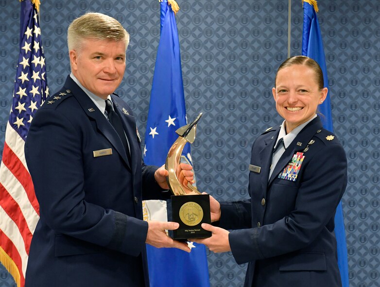 Lt. Gen. Jerry Harris, the deputy chief of staff for strategic plans, programs and requirements, presents Maj. Jessica Stewart the Gen. Lew Allen Jr. Trophy for 2016 during a ceremony at the Pentagon, April 21, 2017. (U.S. Air Force photo/Wayne A. Clark)