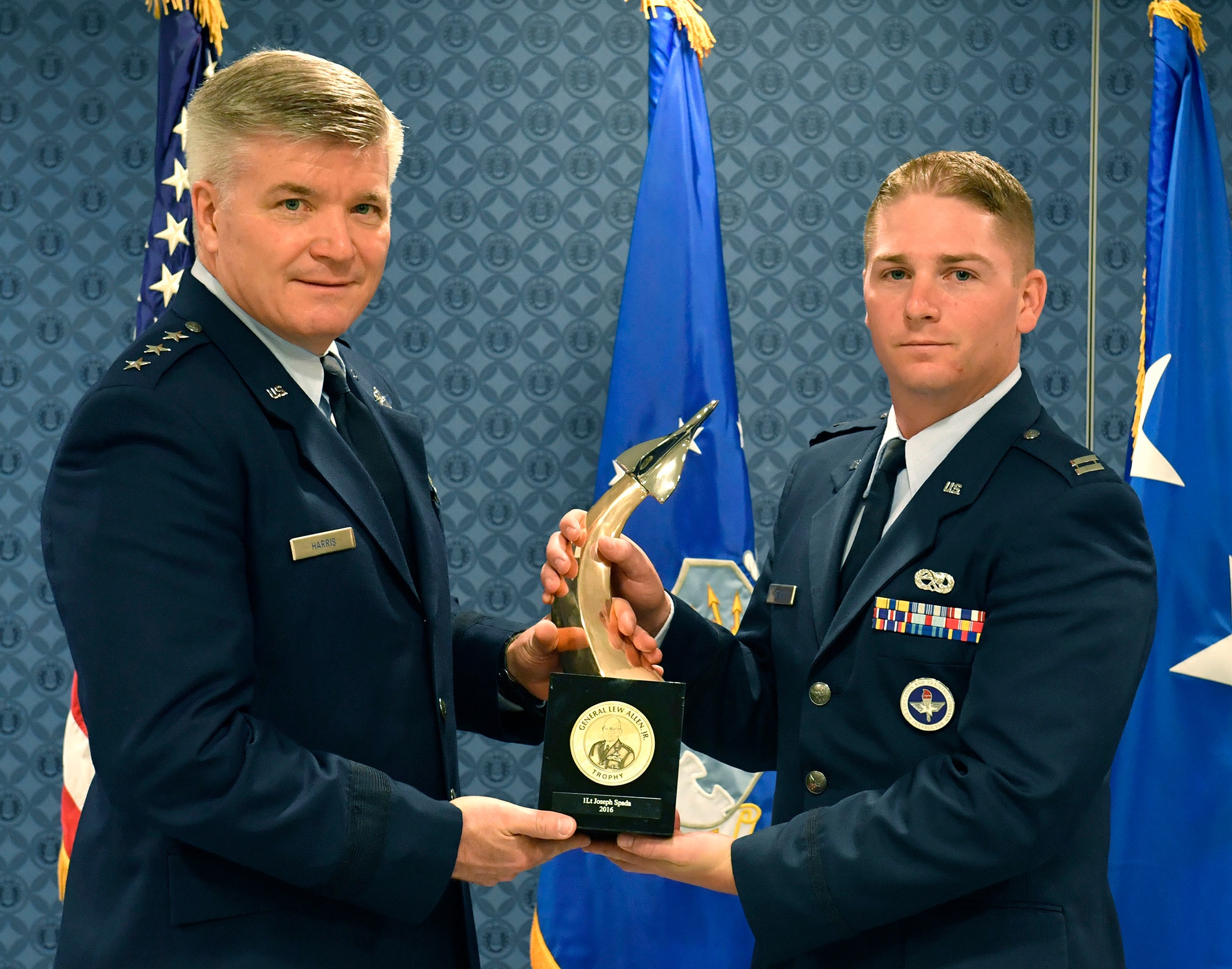Lt. Gen. Jerry Harris, the deputy chief of staff for strategic plans, programs and requirements, presents Capt. Joseph Spada the Gen. Lew Allen Jr. Trophy for 2016 during a ceremony at the Pentagon, April 21, 2017. (U.S. Air Force photo/Wayne A. Clark)