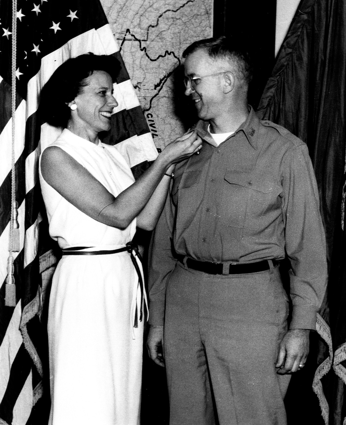 Barbara Raymond pins the rank of colonel on her husband, Lt. Col. Daniel A. Raymond, who was then the Mobile District Commander.
