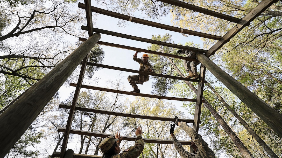 Army Staff Sgt. Edward French maneuvers through the weaver obstacle during an obstacle course event at Fort A.P. Hill, Va., April 18, 2017, as part of the 2017 Spc. Hilda I. Clayton Best Combat Camera Competition. Clayton was a combat camera photographer who died in Afghanistan in 2013 while supporting Operation Enduring Freedom. Army photo by Staff Sgt. Edward Reagan