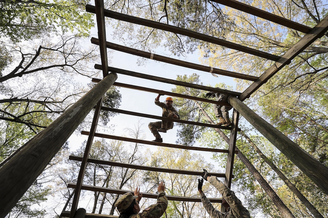 Army Staff Sgt. Edward French maneuvers through the weaver obstacle during an obstacle course event at Fort A.P. Hill, Va., April 18, 2017, as part of the 2017 Spc. Hilda I. Clayton Best Combat Camera Competition. Clayton was a combat camera photographer who died in Afghanistan in 2013 while supporting Operation Enduring Freedom. Army photo by Staff Sgt. Edward Reagan