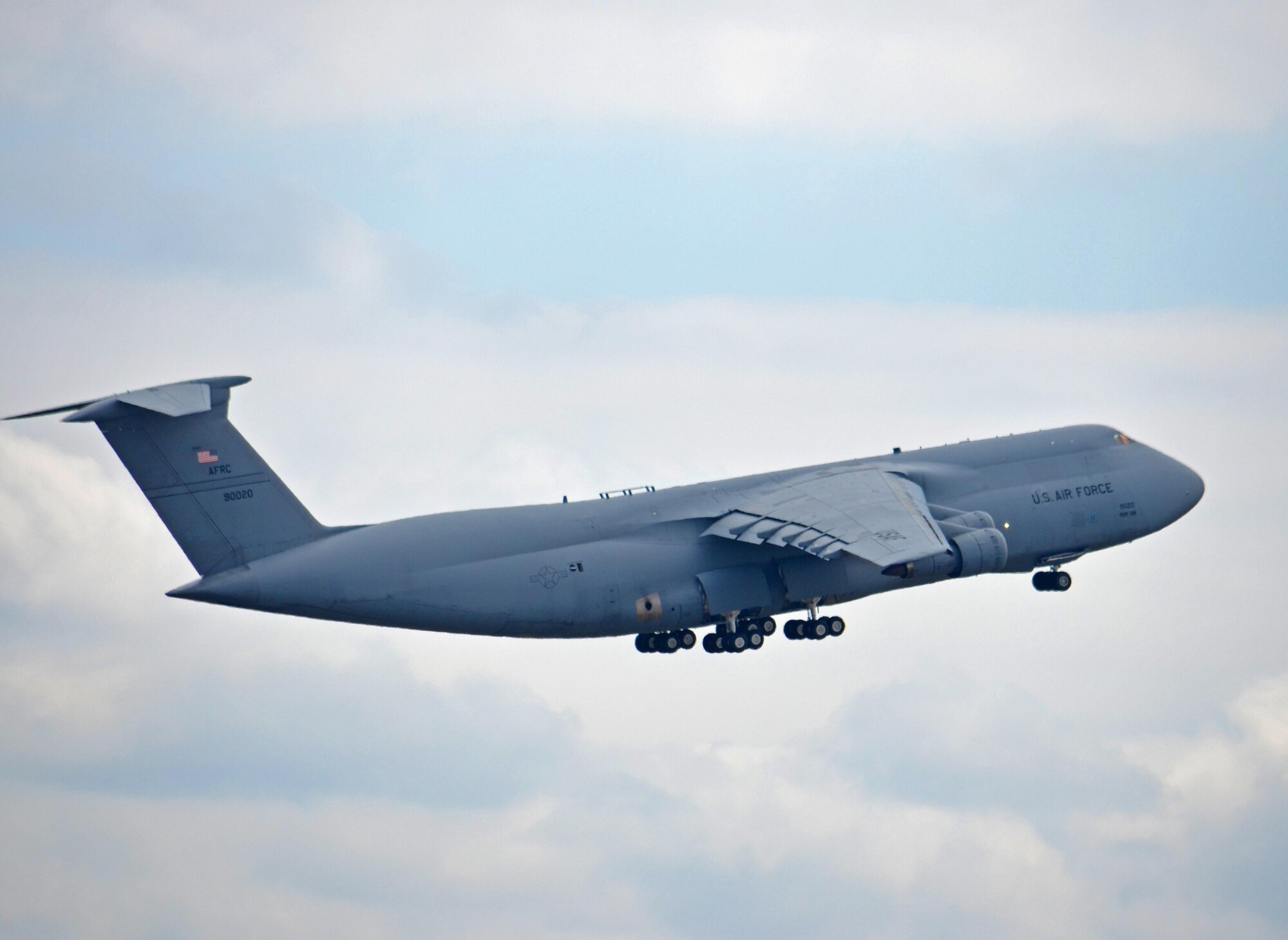 The oldest C-5 in the Air Force fleet departed Westover April 20 for the boneyard in Arizona. Tail 69-0020 – one of the original C-5s assigned to the 439th Airlift Wing when C-5 operations began at Westover in 1987 – lifted into cloudy horizon on its last flight for Davis-Monthan Air Force Base, near Tucson. According to statistics from the 439th Maintenance Group, this Galaxy was assigned to the 433rd Airlift Wing at Joint Base Lackland-San Antonio. It’s been among several loaner A models assigned to Westover to help bridge the gap between the 439th AW’s conversion from B to M models. This C-5, built in 1969, had more than 21,000 flight hours. It was first delivered to the 60th Military Airlift Wing at Travis Air Force Base, Calif., in November 1971. The remaining three C-5As at Westover are scheduled to be retired by the end of the summer, as the conversion to the Super Galaxies gets under way. 