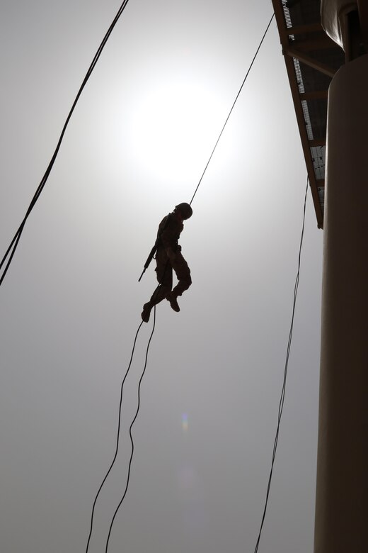 A U.S. Servicemember navigates the rappel tower during day eight of U.S. Army Central’s first Air Assault Course, April 12, 2017, at Camp Buehring, Kuwait. The 50-foot rappel tower is one test within the three-phase course soldiers have to pass to attain the air assault badge. The Air Assault Course is a 12-day class that allows U.S. military personnel in the U.S. Army Central area of operations the unique opportunity to become air assault qualified, while deployed outside the continental United States.