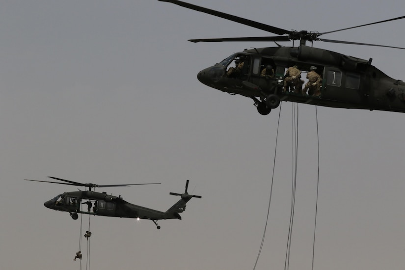 U.S. Servicemembers rappelling out of UH-60 Black Hawk helicopters during day nine of U.S. Army Central’s first Air Assault Course, April 13, 2017 at Camp Beuhring, Kuwait. The Air Assault Course is a 12-day class that allows U.S. military personnel in the USARCENT area of operations the unique opportunity to become air assault qualified, while deployed outside the continental United States.