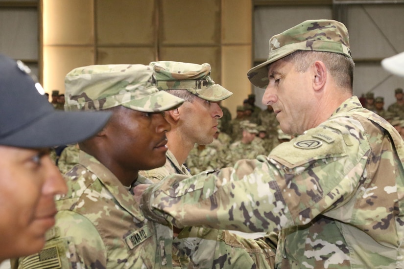 U.S. Army Maj. Gen. William Hickman (right), deputy commanding general of U.S. Army Central, pins air assault wings on one of the Air Assault Course’s honor graduates Sgt. Carl Howard, combat medic, 215th Brigade Support Battalion, 3rd Armored Brigade Combat Team, 1st Cavalry Division, during graduation day, April 14, 2017, at Camp Beuhring, Kuwait. The Air Assault Course is a 12-day class that allows U.S. military personnel in the U.S. Army Central area of operations the unique opportunity to become air assault qualified, while deployed outside the continental United States.