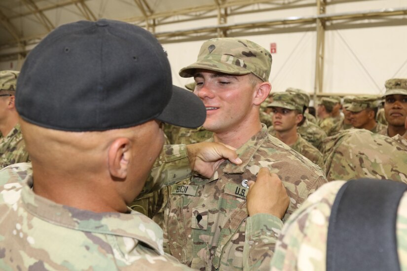 U.S. Army Spc. John Egizii, diver, 511th Dive Detachment, gets his air assault wings pinned by an Air Assault instructor, during graduation day of U.S. Army Central’s first Air Assault Course, April 14, 2017, at Camp Beuhring, Kuwait. The Air Assault Course is a 12-day class that allows U.S. military personnel in U.S. Army Central area of operations the unique opportunity to become air assault qualified, while deployed outside the continental United States.