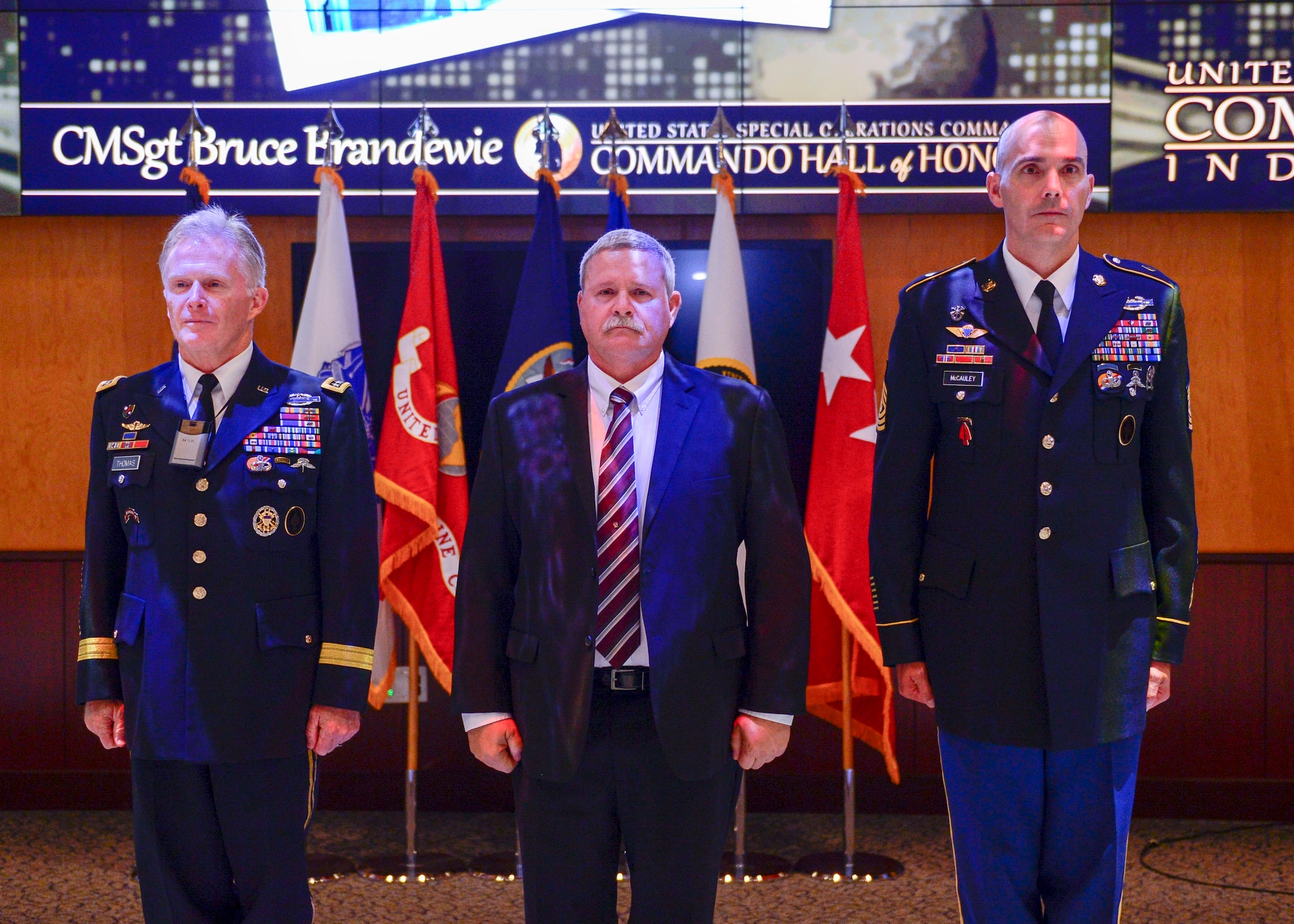Army Gen. Raymond A. Thomas, USSOCOM commander, and Command Sgt. Maj. Patrick L. McCauley, USSOCOM command senior enlisted adviser recognizes Chief Master Sgt. Bruce Brandewie during the 2017 Commando Hall of Honor Ceremony located at the USSOCOM headquarters, MacDill Air Force Base, Florida, April 18.  CMSgt  Brandewie embody the skills, values, spirit and courage of a Special Operations Forces Warrior and was one of the seven inductees that were honored during this ceremony.  