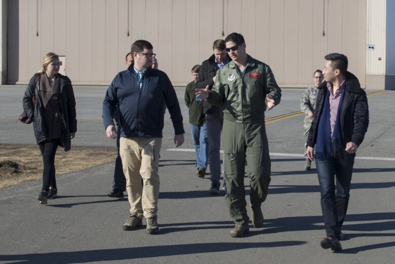 U.S. Air Force Capt. Jack Johnston, an 18th Aggressor Squadron F-16 Fighting Falcon aircraft pilot, speaks with Congressional staff delegates 18 April, 2017, at Eielson Air Force Base, Alaska. One stop during the base tour involved a static display of the F-16, which recently received the new “Splinter” pattern. 