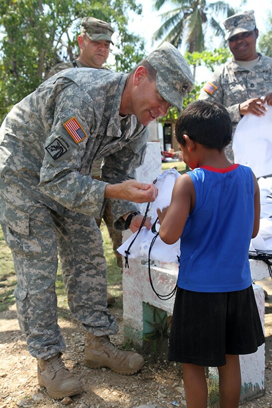 Army Sgt. 1st Class Eric Ritchey, a team leader with the 413th Civil Affairs Battalion, hands out school supplies to children at the Liberty Children's Home in Ladyville, Belize, April 18, 2017. Ritchey and other U.S. soldier participated in the community relations event as part of Beyond the Horizon 2017. The event is a partnership exercise between the government of Belize and U.S. Southern Command that will provide three free medical service events and five construction projects throughout the country of Belize from March 25 until June 17. Army photo by Staff Sgt. Fredrick Varney