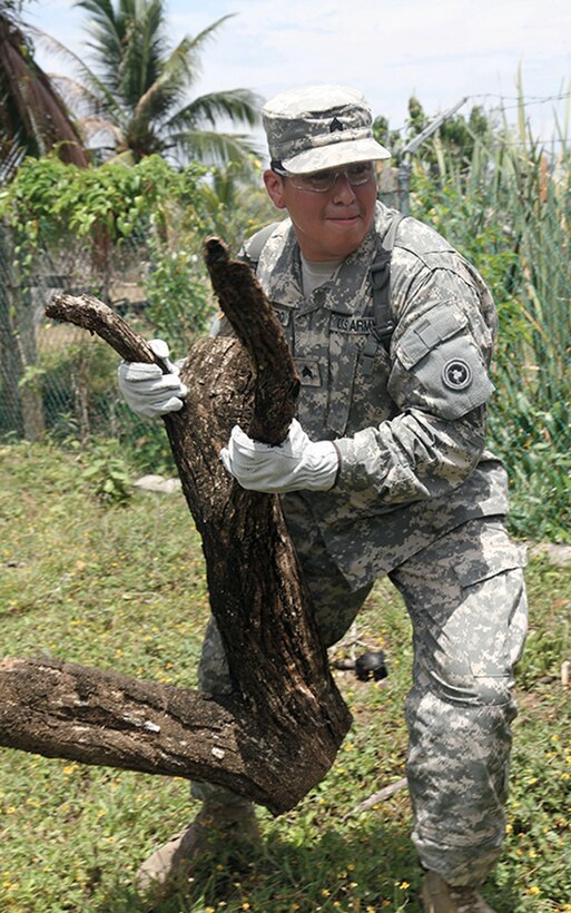 Army Sgt. Alex Navarro, a mechanic with the 452nd Quartermaster Company, disposes of a fallen tree stump at the Liberty Children's Home, during a community relations event held in Ladyville, Belize as part of Beyond the Horizon 2017, April 18, 2017. Service members helped to clear debris from the property and played games with the children. Army photo by Staff Sgt. Fredrick Varney