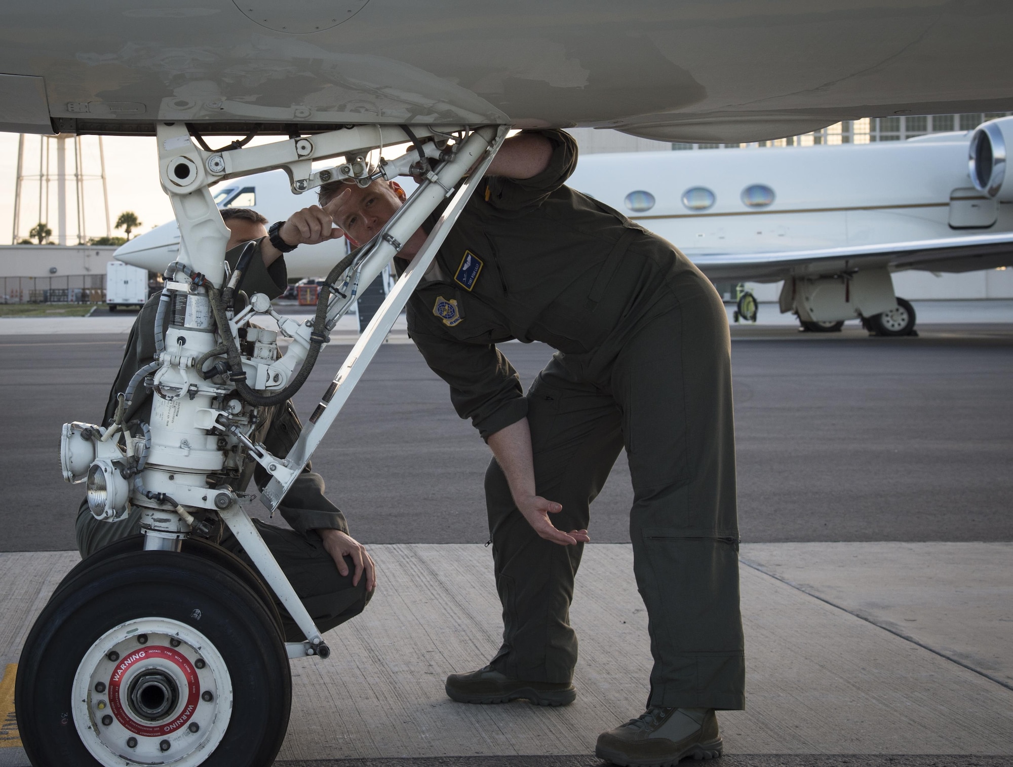 U.S. Air Force Tech. Sgt. Ben Doyle, left, the NCO in charge of flight engineers, and Tech. Sgt. Ryan Lilly, right, a flight engineer assigned to the 310th Airlift Squadron, inspect the landing gear on a C-37A Gulfstream at MacDill Air Force Base, Fla., April 13, 2017. Flight engineers must inspect both the inside and outside of the aircraft before take-off. (U.S. Air Force photo by Airman 1st Class Mariette Adams)