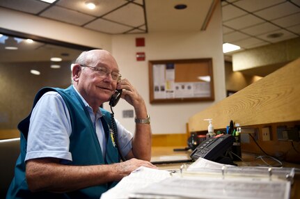 Wilford Hall volunteer Jack Kuttner answers the phone while manning the information desk at the Wilford Hall Ambulatory Surgical Center, Joint Base San Antonio-Lackland, Texas, April 12, 2017. Volunteers can be spotted throughout Wilford Hall assisting patients and staff members.
