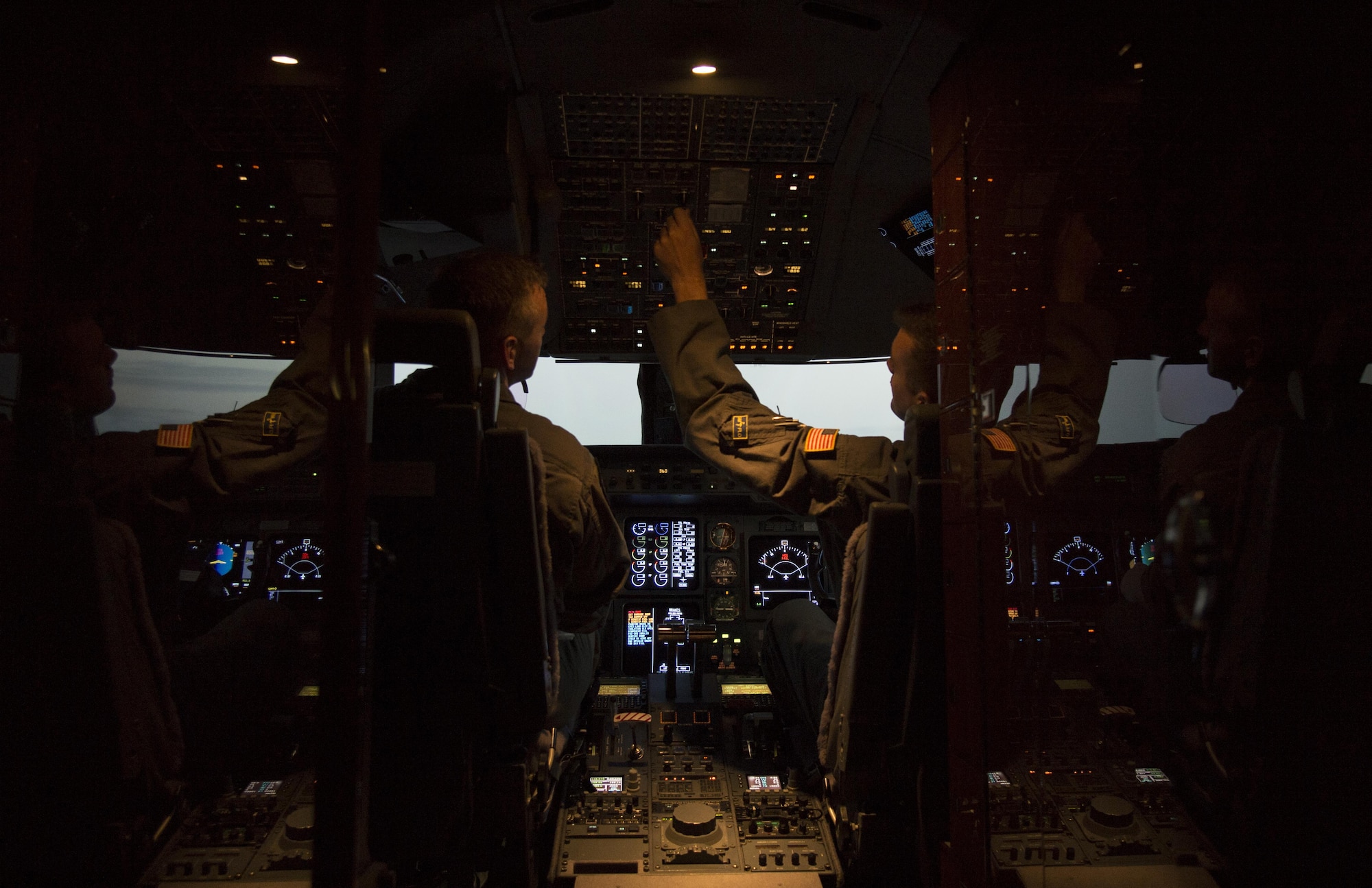 U.S. Air Force Tech. Sgt. Ryan Lilly, left, a flight engineer, and Tech. Sgt. Ben Doyle, right, the NCO in charge of flight engineers assigned to the 310th Airlift Squadron, preform preflight checklist procedures at MacDill Air Force Base, Fla., April 13, 2017. Preflight checklists are completed before every flight. (U.S. Air Force photo by Airman 1st Class Mariette Adams)