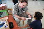 Lt. Col. Erin Merryweather, deputy commander of clinical services, Utah Medical Command, evaluates a young patient in Ladyville, Belize, April 18, 2017, during a community relations event held as part of Beyond the Horizon 2017. Army Photo by Staff Sgt. Fredrick Varney
