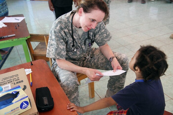 Lt. Col. Erin Merryweather, deputy commander of clinical services, Utah Medical Command, evaluates a young patient in Ladyville, Belize, April 18, 2017, during a community relations event held as part of Beyond the Horizon 2017. Army Photo by Staff Sgt. Fredrick Varney