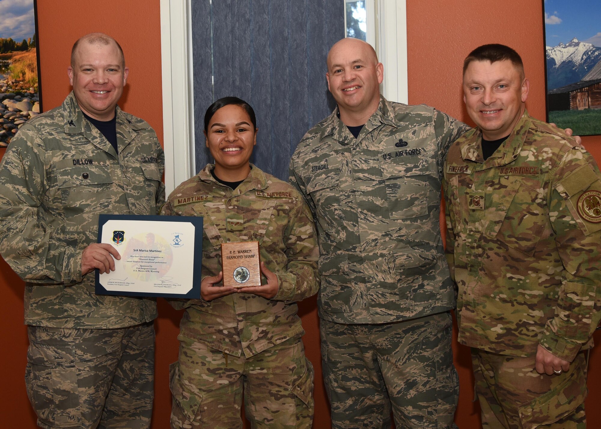 Senior Airman Marisa Martinez (second from left) supply and resources technician, with the 90th Missile Security Forces Squadron, poses for a photo accepting the Diamond Sharp award. Posing with Martinez from the left, are Col. Matthew Dillow, 90th Missile Wing vice commander, Chief Master Sgt. Jeffery Steagall, 90th Missile Wing command chief, Master Sgt. Brandon Finefrock, 90th Missile Security Forces Squadron first sergeant. The award is presented monthly to three Airmen chosen by the Warren First Sergeants council. (U.S. Air Force photo by Glenn Robertson) 