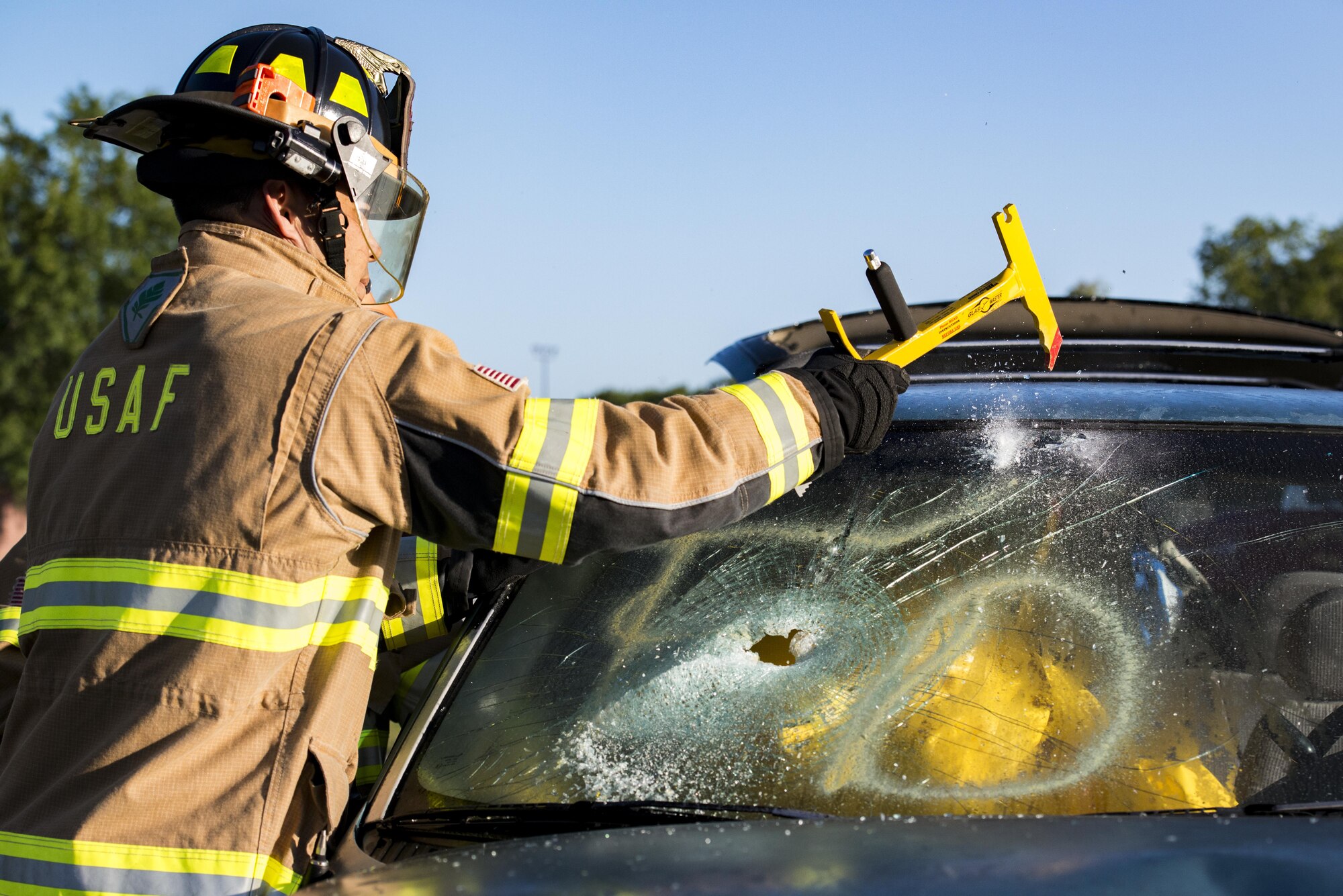 Matthew Perreira, 23d Civil Engineering Squadron firefighter, breaks a windshield during a natural disaster exercise, April 19, 2017, at Moody Air Force Base, Ga. The exercise tested the wing’s ability to evacuate aircraft, secure assets and respond to emergency situations in the event of a real-world natural disaster. (U.S. Air Force photo by Airman 1st Class Lauren M. Sprunk)