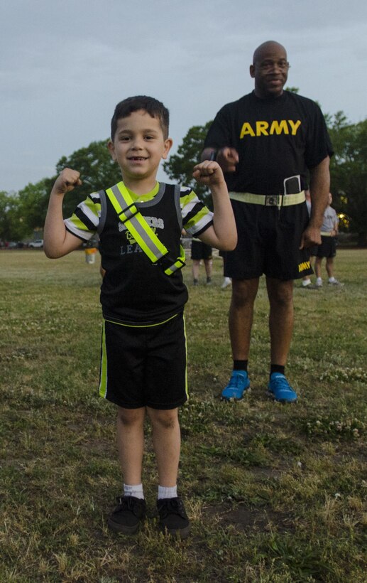 Esteban Aponte, the son of Master Sgt. Esteban Aponte Algarin, the networking and infrastructure noncommissioned in charge for the U.S. Army Reserve Command, flexes after the warm-up before a staff run at Fort Bragg, N.C., April 21, 2017, to celebrate the 109th birthday of the Army Reserve. Created April 23, 1908 as the Medical Reserve Corps, America's Army Reserve of today has transformed into a capable, combat-ready, and lethal Federal reserve force in support of the Army at home and abroad. (U.S. Army Reserve photo by Stephanie Ramirez/Released)