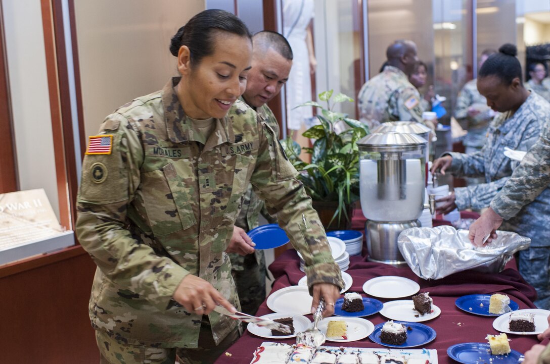 Chief Warrant Officer 3 Ericka Morales, with the U.S. Army Reserve Command protocol office, serves cake to Soldiers and civilians at Fort Bragg, N.C., April 21, 2017, as they celebrate the 109th anniversary of the of the U.S. Army Reserve. Created in 1908 as the Medical Reserve Corps, America's Army Reserve of today has transformed into a capable, combat-ready, and lethal Federal reserve force in support of the Army at home and abroad. (U.S. Army Reserve photo by Timothy L. Hale)(Released)