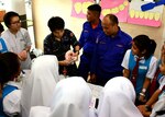 A service member from the Japanese Ground Self-Defence Force and two Malaysian Defence Service personnel demonstrate proper brushing technique on a doll at a Community Health Outreach Event during Pacific Partnership 17 Kuching, April 21, 2017.  Pacific Partnership is the largest annual multilateral humanitarian assistance and disaster relief preparedness mission conducted in the Indo-Asia-Pacific and aims to enhance regional coordination in areas such as medical readiness and preparedness for manmade and natural disasters.