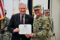 Maj. Gen. Troy D. Kok, commanding general of the U.S. Army Reserve’s 99th Regional Support Command (right), receives a special congressional recognition from Bob Smyth, field representative for U.S. Congressman Tom MacArthur, during the 99th RSC Army Superior Unit Award ceremony April 21 at the command’s headquarters on Joint Base McGuire-Dix-Lakehurst, New Jersey. The 99th RSC received the award for providing aid and assistance from October 2012 to April 2013 to communities in New York City that were devastated by Superstorm Sandy.