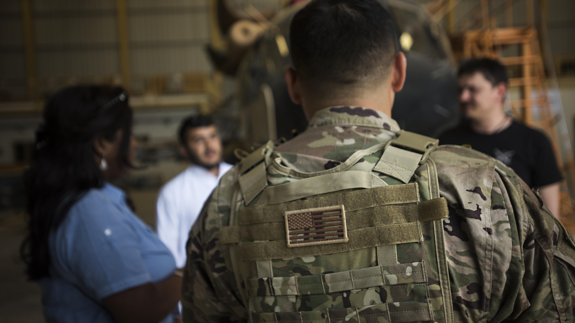 Tech. Sgt. Hector Flores, 738th Air Expeditionary Advisory Group guardian angel, provides armed overwatch for contractors and air advisors performing maintenance on an Afghan Air Force Mi-17 Military Transport Helicopter April 16, 2017, at Kandahar Air Wing, Afghanistan. Flores is deployed with other Citizen Airmen from the 507th Security Forces Squadron, Tinker Air Force Base, Okla. (U.S. Air Force photo/Staff Sgt. Katherine Spessa)