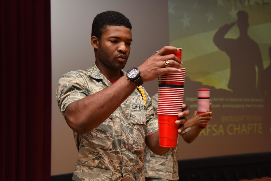 Airman 1st Class Jordan Williams, 335th Training Squadron student, participates in an interactive, team building exercise during the Airmen Building Airmen Symposium at the Welch Theater April 21, 2017, on Keesler Air Force Base, Miss. The Air Force Sergeants Association Chapter 652, sponsored the event designed to inspire young Airmen and help them develop their leadership skills.  (U.S. Air Force photo by Kemberly Groue)