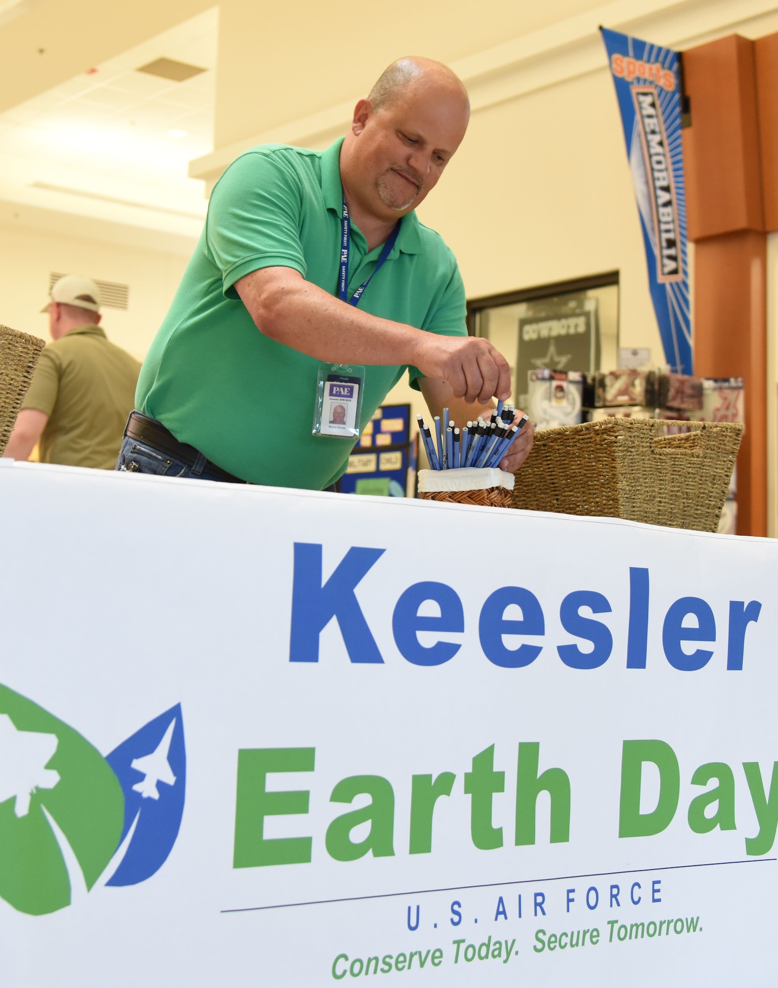 Bruce Groves, Base Operations Support energy manager, adjusts pencils made of recycled material in the base exchange April 21, 2017, on Keesler Air Force Base, Miss. The base operations support energy program and environmental office staffs set-up a booth with hand-outs and reading materials about recycling and environmental sustainability for Keesler personnel in recognition of Earth Day. (U.S. Air Force photo by Kemberly Groue)

