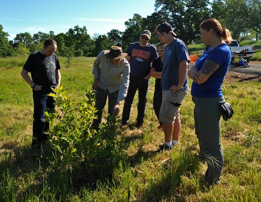 Chadwick McCready, 9th Civil Engineer Squadron biologist teaches a group of volunteers facts about native tree species April 21, 2017 at Beale Air Force Base, California. The group planted 16 seedlings and saplings. (U.S. Air Force photo/Airman 1st Class Tristan D. Viglianco)