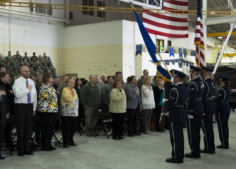 Ceremony attendees stand for the National Anthem at the Gantzer Maintenance Facility at Minot Air Force Base, N.D., April 21, 2017. The hangar was named in honor of Chief Master Sgt. Fred Gantzer, who served at Minot AFB for over a decade. (U.S. Air Force photo/Airman 1st Class Alyssa M. Akers)