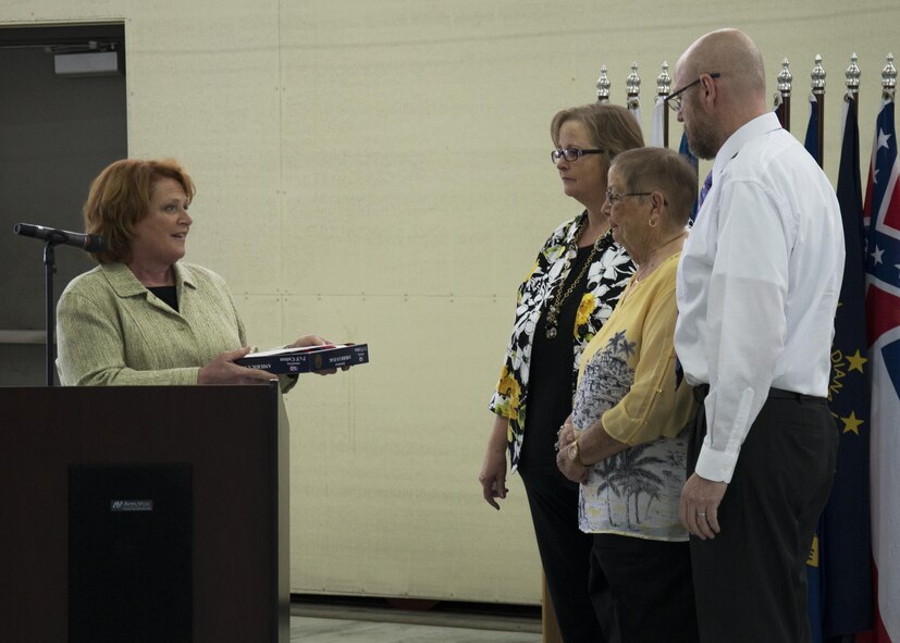 North Dakota Senator Heidi Heitkamp presents a flag to the Gantzer family at the Gantzer Maintenance Facility at Minot Air Force Base, N.D., April 21, 2017. The flag was flown over Washington D.C. in honor of Chief Master Sgt. Fredrick Gantzer, whom the hangar is named after. (U.S. Air Force photo/Airman 1st Class Alyssa M. Akers)