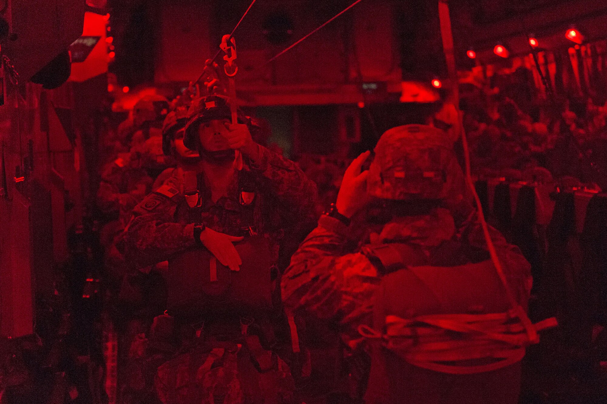 Paratroopers with the 4th Infantry Brigade Combat Team (Airborne), 25th Infantry Division, U.S. Army Alaska, prepare to jump from a C-17 Globemaster III during a night jump at the Malemute Drop Zone at Joint Base Elmendorf-Richardson, Alaska, April 18, 2017. Routine jump training is conducted to maintain proficiency and train for prospective missions. 