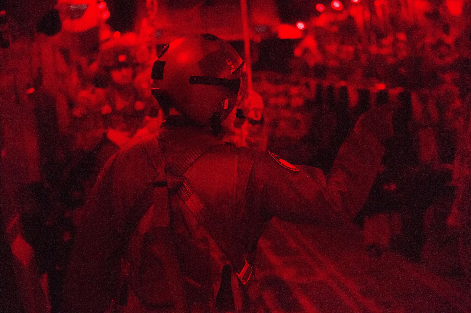 A loadmaster prepares to open the door of a C-17 Globemaster III for paratroopers with 4th Infantry Brigade Combat Team (Airborne), 25th Infantry Division, U.S. Army Alaska, before a night jump at the Malemute Drop Zone at Joint Base Elmendorf-Richardson, Alaska, April 18, 2017. Routine jump training is conducted to maintain proficiency and train for prospective missions. 