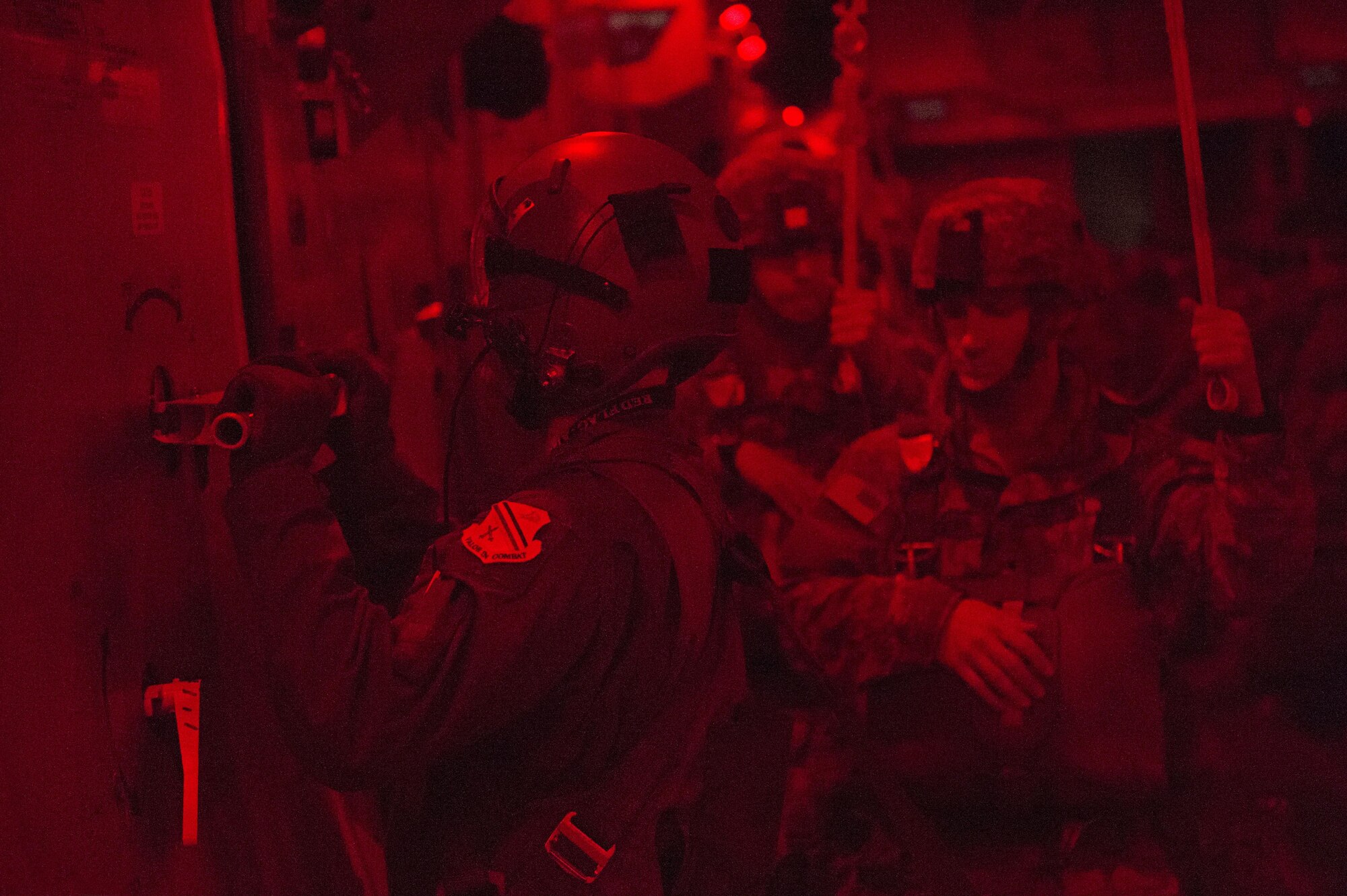 A loadmaster opens the door of a C-17 Globemaster III for paratroopers with 4th Infantry Brigade Combat Team (Airborne), 25th Infantry Division, U.S. Army Alaska, during a night jump at the Malemute Drop Zone at Joint Base Elmendorf-Richardson, Alaska, April 18, 2017. Routine jump training is conducted to maintain proficiency and train for prospective missions. 