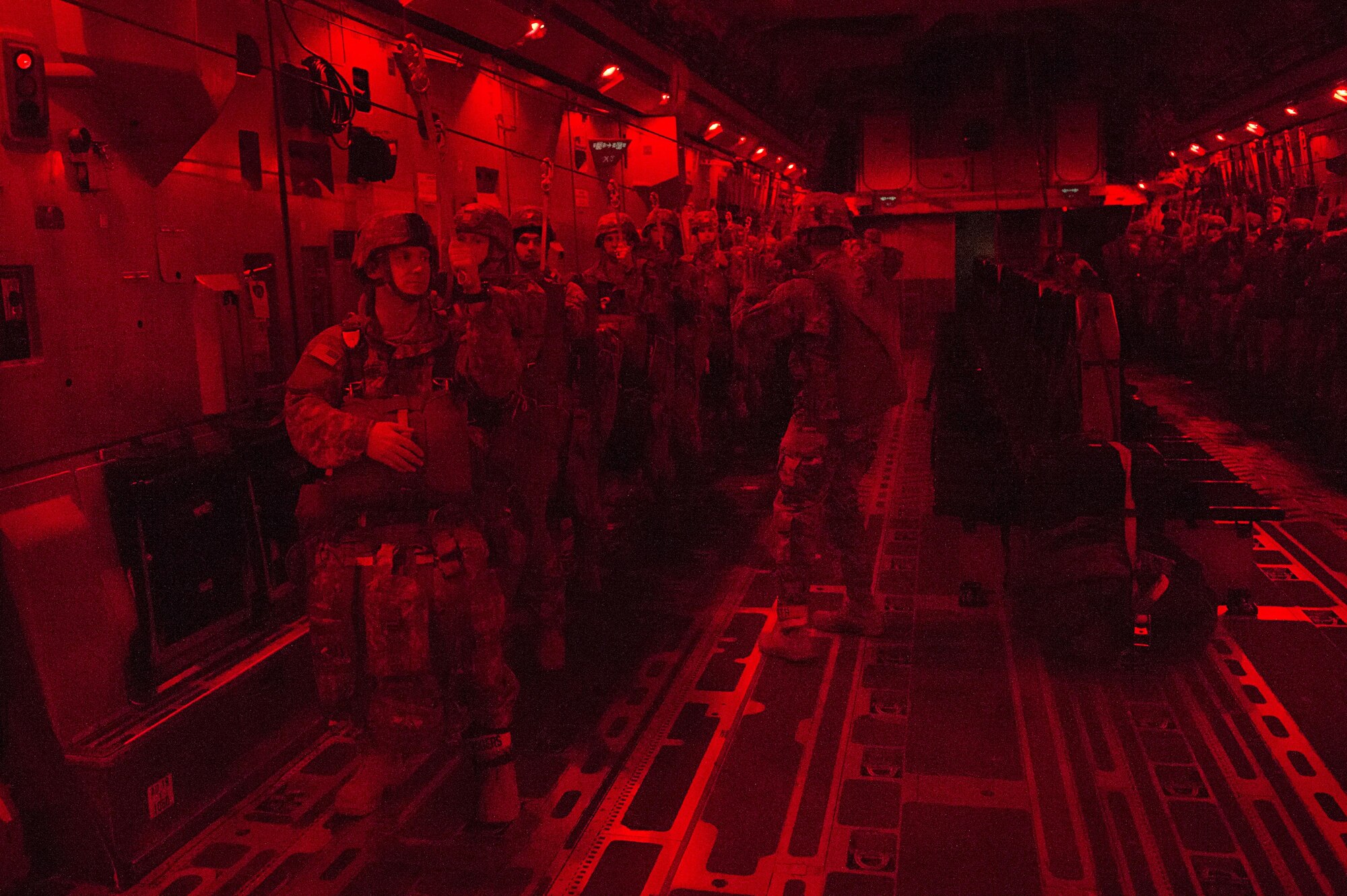 Paratroopers with the 4th Infantry Brigade Combat Team (Airborne), 25th Infantry Division, U.S. Army Alaska, prepare to jump from a C-17 Globemaster III during a night jump at the Malemute Drop Zone at Joint Base Elmendorf-Richardson, Alaska, April 18, 2017. Routine jump training is conducted to maintain proficiency and train for prospective missions. 