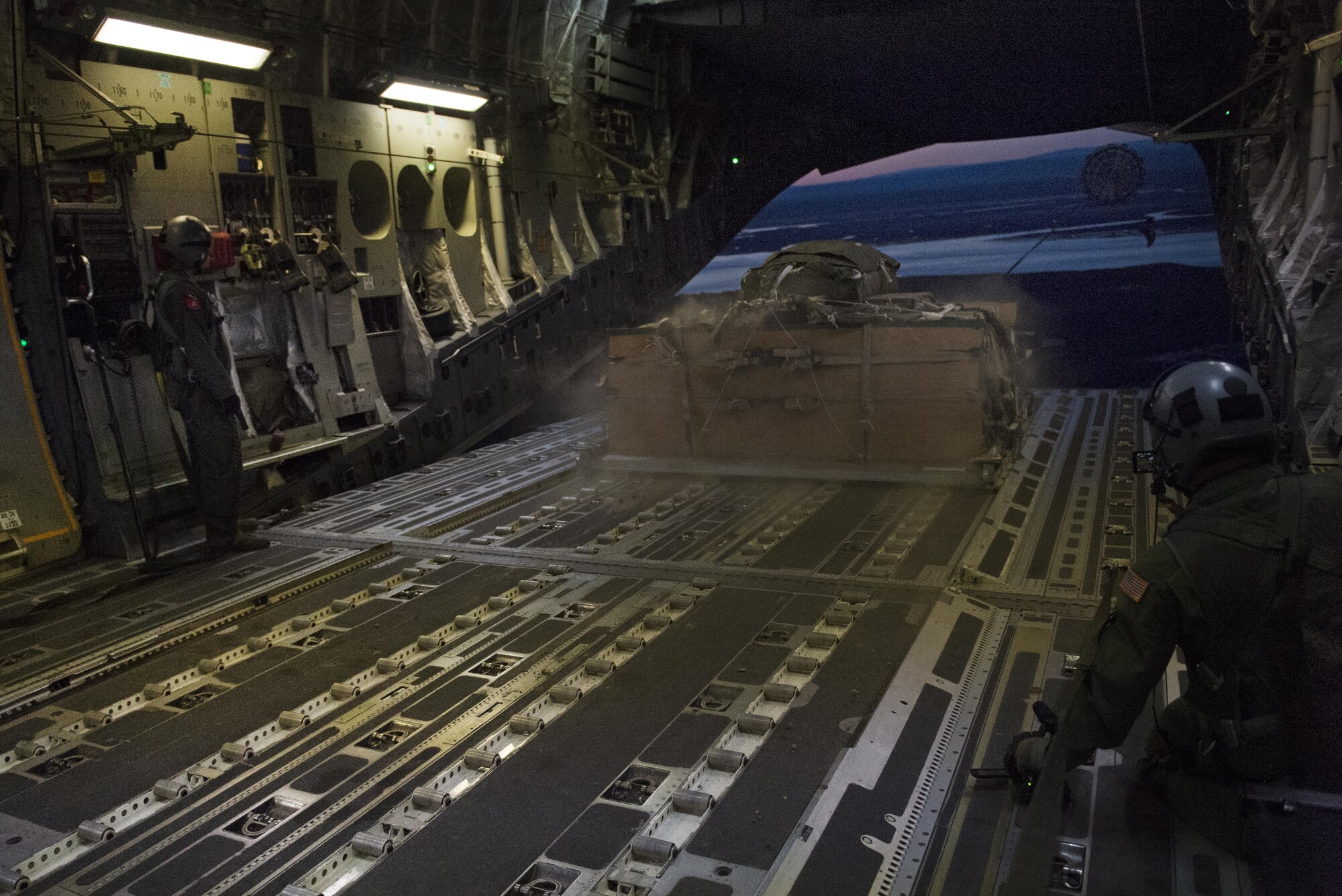 A C-17 Globemaster III aircraft drops cargo during a training mission at the Malemute Drop Zone at Joint Base Elmendorf-Richardson, Alaska, April 18, 2017. The training involved an air refueling mission, a cargo drop and a night jump for paratroopers with the 4th Infantry Brigade Combat Team (Airborne), 25th Infantry Division, U.S. Army Alaska. 