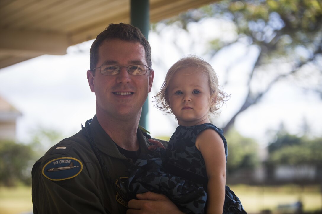 Lt. j.g. John Wylie, an intelligence officer assigned to Patrol Squadron 47, poses with his daughter during a Yellow Ribbon Day celebration at Aikahi Elementary School on April 7, 2017. Yellow Ribbon Day is part of April's “Month of the Military Child,” which acknowledges and honors the sacrifices made by children with parents in the armed services. (U.S. Marine Corps photo by Lance Cpl. Matthew Kirk)