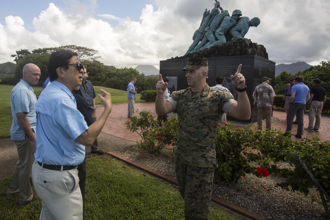 Lt. Col. Brian Cohn, the operations officer for Marine Corps Base Hawaii, talks to a college professor about the history of the base during a tour at the Pacific War Memorial aboard MCB Hawaii on April 13, 2017. The group visited the base to build a better understanding of how the military operates in the Pacific. (U.S. Marine Corps photo by Lance Cpl. Isabelo Tabanguil)